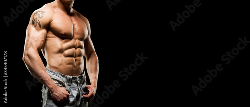 Obraz na plátně Portrait of strong healthy power fitness handsome athletic man with muscular trained body on black background
