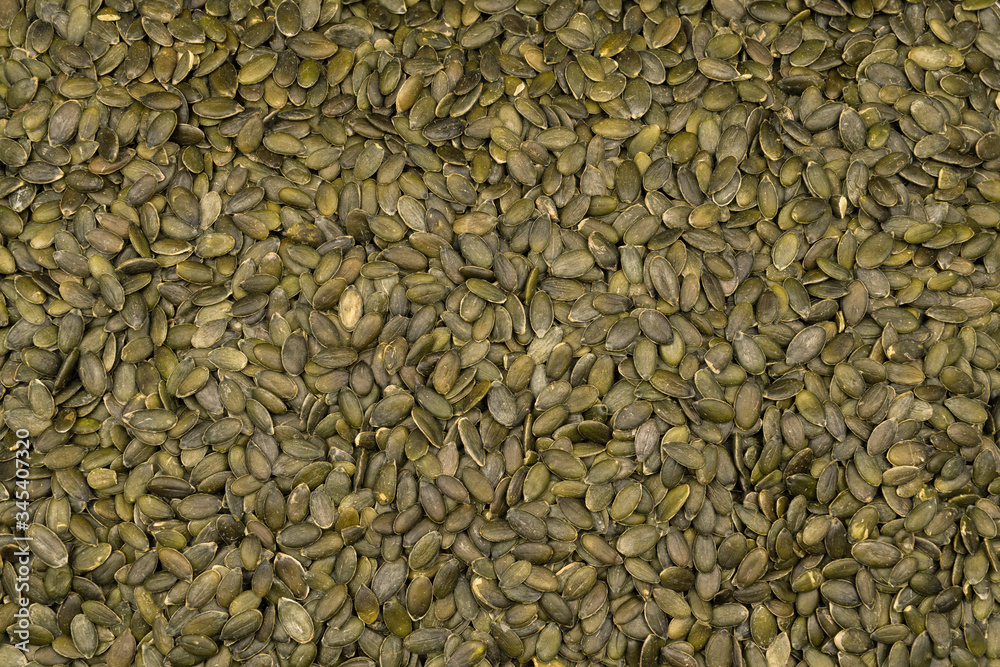 Heap of raw pumpkin seeds as a background Heap of raw pumpkin seeds as a background