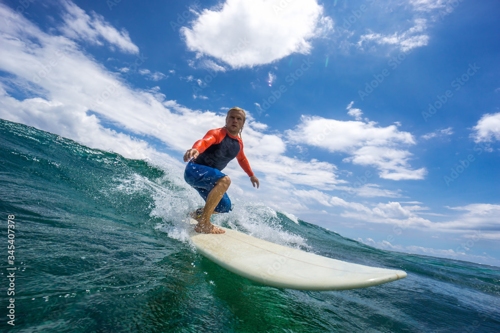 muscular surfer with long white hair riding on big waves on the Indian Ocean island of Mauritius muscular surfer with long white hair riding on big waves on the Indian Ocean island of Mauritius