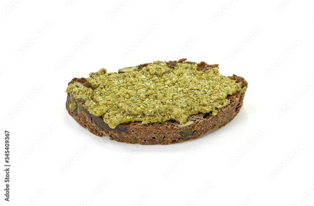 Fresh tasty home made bread with pesto, basil and parmesan on white background