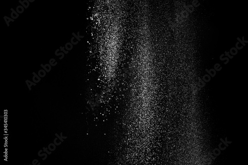 White fluffy snow on small particles isolated on black background