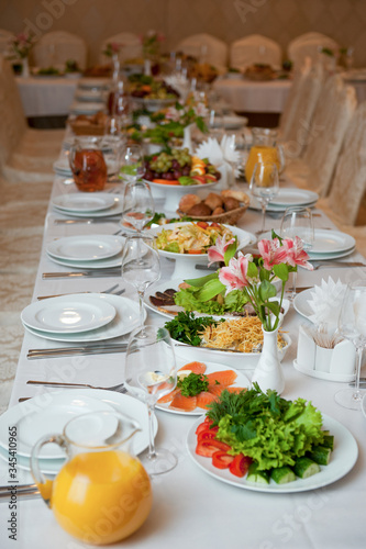 set Banquet table with white dishes and flower