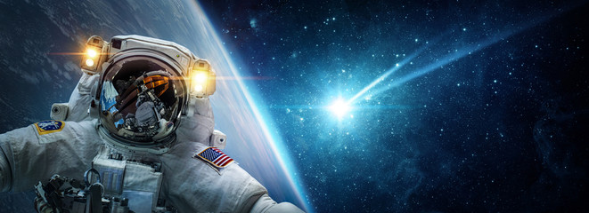 Astronaut in orbit of planet Earth against the background of a falling meteorite, asteroid, comet. The concept on the theme apocalypse, armageddon, doomsday,. Elements of this image furnished by NASA.