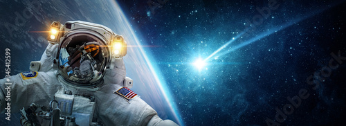Vászonkép Astronaut in orbit of planet Earth against the background of a falling meteorite, asteroid, comet
