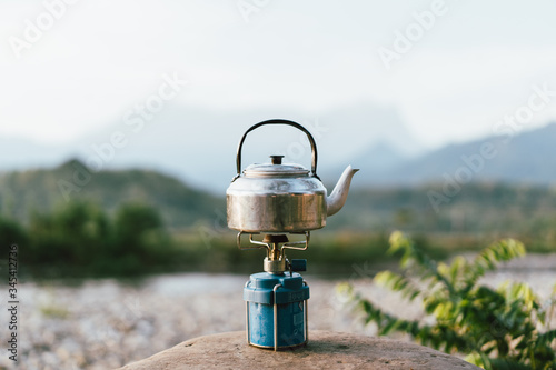 Malaysia, 3 May 2020 - Camping stove with kettle standing on a rock during camping