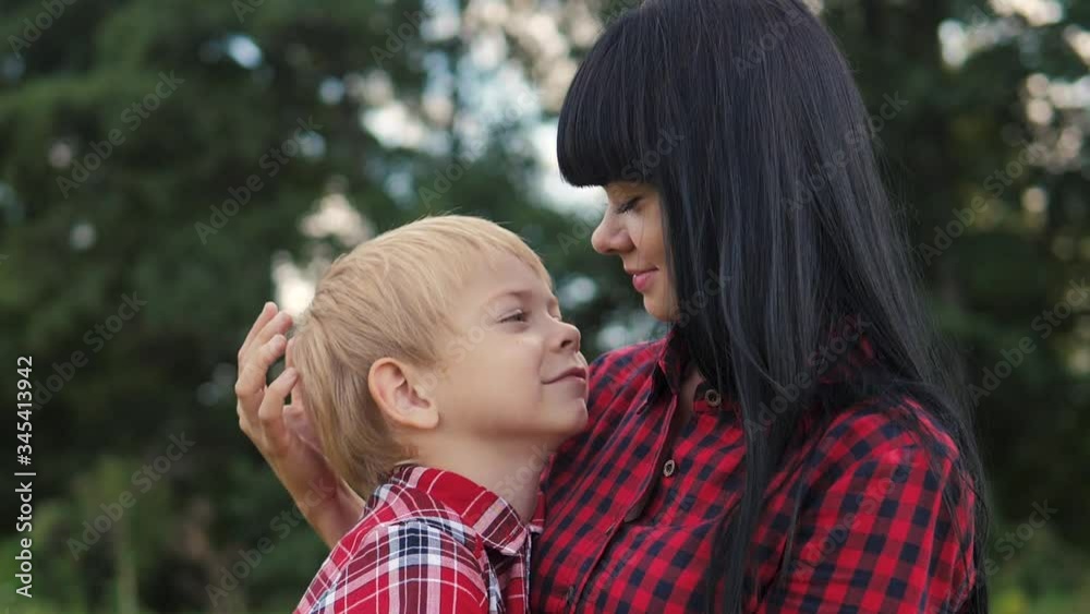 happy family mom and son concept . mom tender childhood video . slow motion video . mom a brunette girl gently lifestyle hugs takes care of the boy son blonde outdoors happy family mom and son concept . mom tender childhood video . slow motion video . mom a brunette girl gently lifestyle hugs takes care of the boy son blonde outdoors