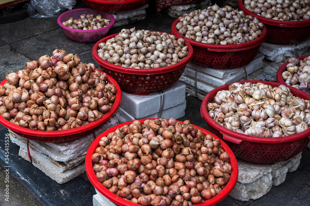 Baskets with garlic and onion on the traditional  street market, Hanoi, Vietnam.