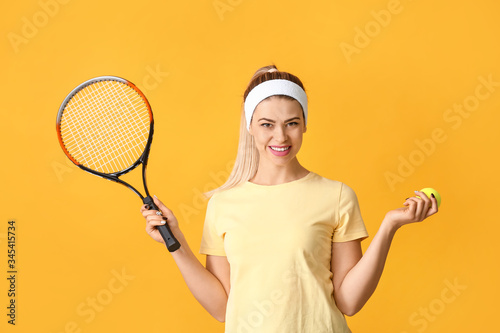 Portrait of beautiful tennis player on color background