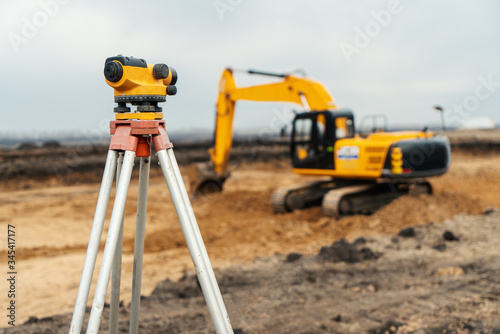 Surveyor equipment tacheometer or theodolite outdoors at construction site photo