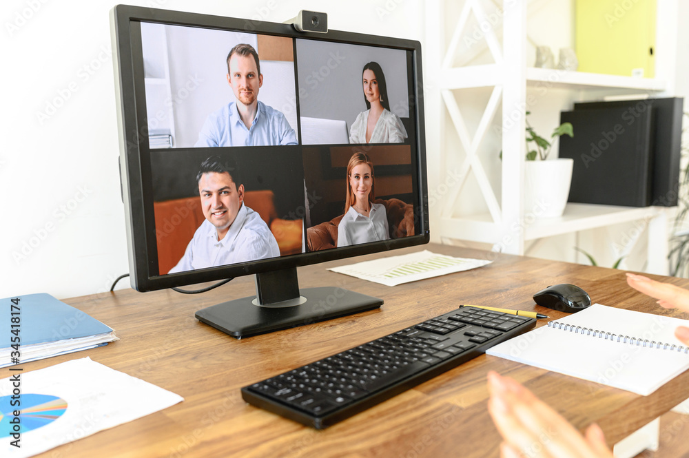 Close up pc screen with video conference on the table. Video call, video meeting