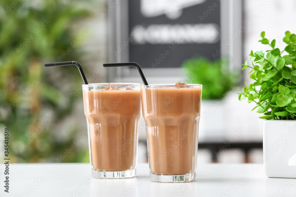 Glasses of tasty iced coffee on table in cafe Glasses of tasty iced coffee on table in cafe