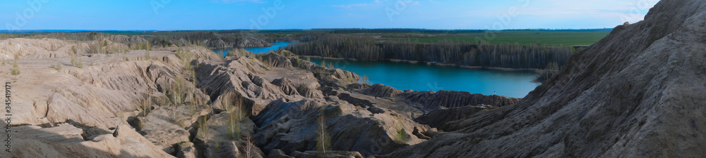 Sandy quarry with blue water called Conduky or Romance Mountains panorama