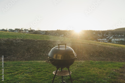Barbecue grill on green lawn.