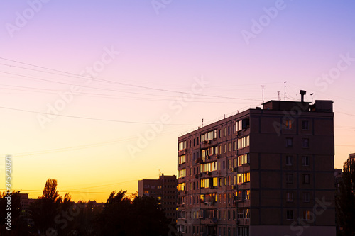 Autumn evening. Sunset. In the frame, a residential building against the blue sky. Beautiful gradient from the horizon up. Photographed in Ukraine, Kiev region.