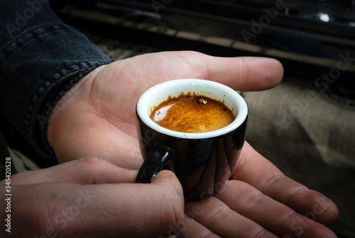 Barista makes espresso coffee in cafe closeup