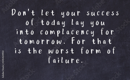 Chalk inscription of smart quote on black desk