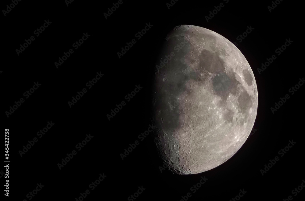 First quarter of the moon is seeing on the night sky First quarter of the moon is seeing on the night sky