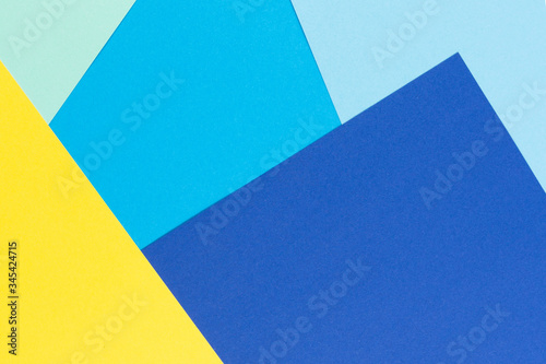 Abstract color papers geometry flat composition background with yellow and blue tones