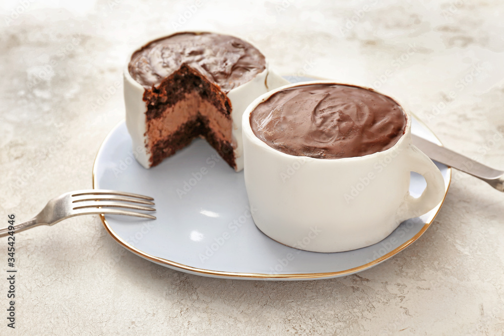 Chocolate cakes in shape of coffee cups on color background Chocolate cakes in shape of coffee cups on color background