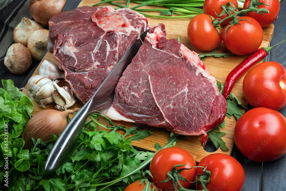 A juicy piece of fresh meat. Meat and vegetables. Cooking meat. A chef's knife. Balanced diet. Red meat. A juicy piece of fresh meat. Meat and vegetables. Cooking meat. A chef's knife. Balanced diet. Red meat.