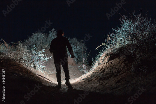 Man exploring unique landscape with flashlight