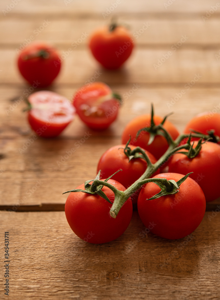 Small tomatoes on a wooden table Small tomatoes on a wooden table