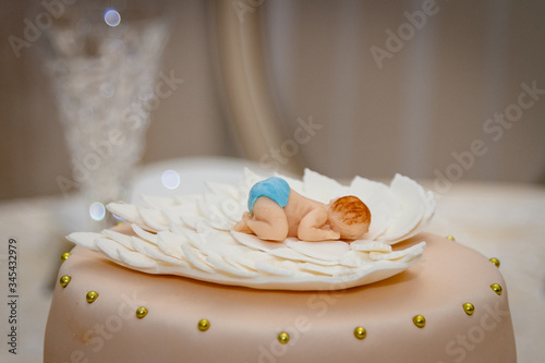 Cake for the baby. Toddler on the wings of an angel.