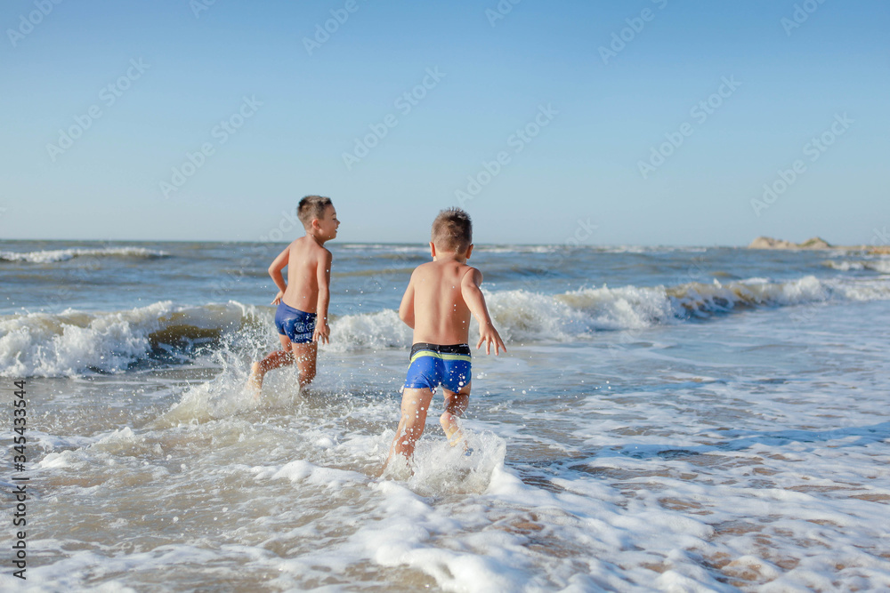 kids running on the beach kids running on the beach