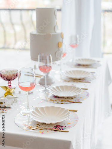 Birthday or wedding table setting in white colors with cocktails in glasses. Baby shower or girl party. Selective focus