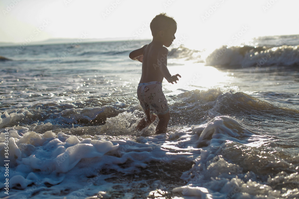 kid running on the beach