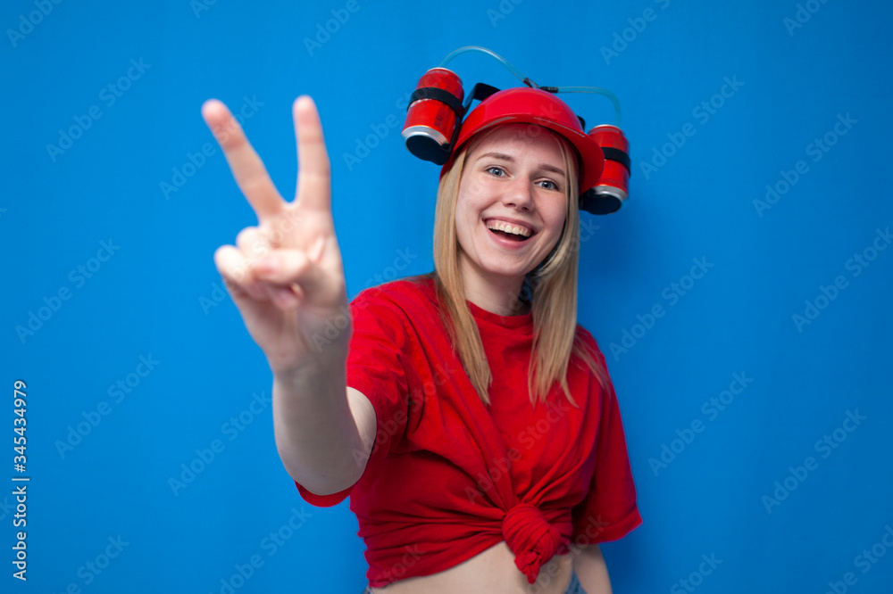 girl fan shows fingers number two on a blue background and smiles, cheerleader in uniform girl fan shows fingers number two on a blue background and smiles, cheerleader in uniform