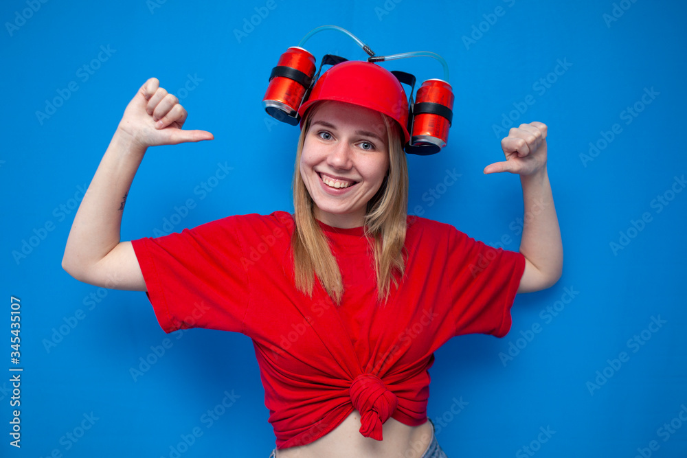 portrait of a young female fan in red uniform on a blue background, a cheerful cheerleader is smiling portrait of a young female fan in red uniform on a blue background, a cheerful cheerleader is smiling