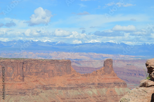 Rock formations at Dead Horse Point with Potash Ponds and the snowcapped La Sal Mountain range in the distance, Utah