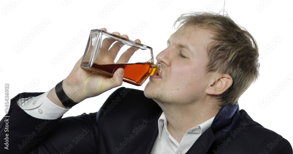 Sleepy young tired businessman. Depressed disheveled worker drink alcohol cognac Sleepy young tired businessman. Depressed disheveled worker drink alcohol cognac