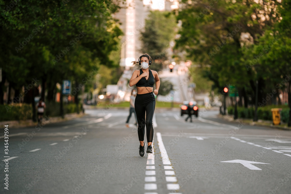 girl does sports with a mask on the street during the confinement of coronavirus girl does sports with a mask on the street during the confinement of coronavirus