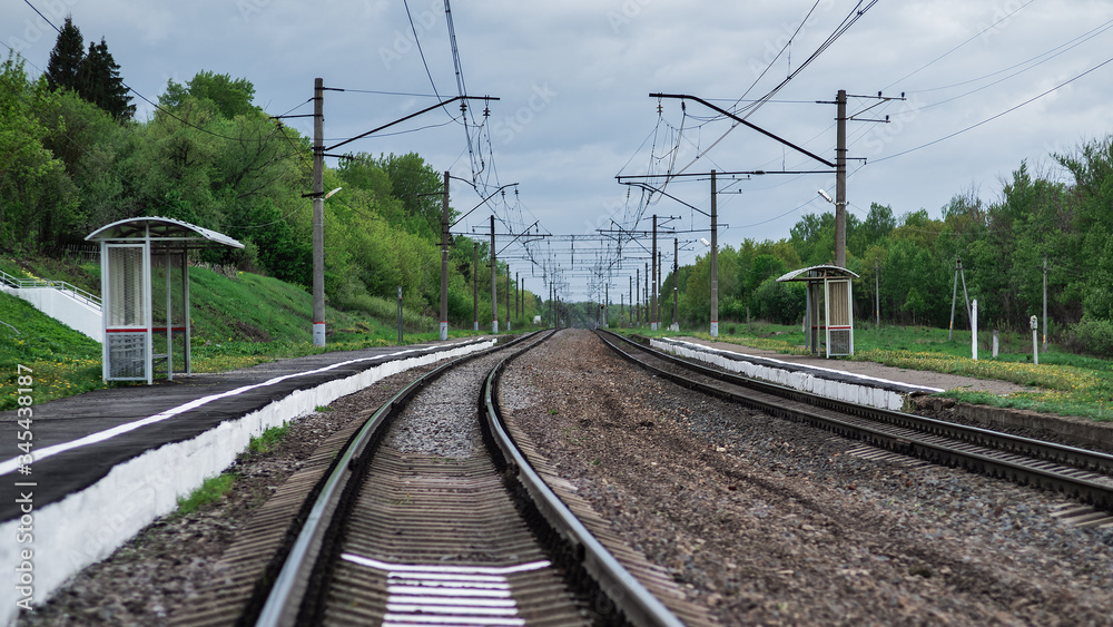 Railway landscape. Suburban railway station in the woody area. Railway landscape. Suburban railway station in the woody area.