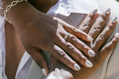 Obraz na płótnie Bride and groom exchanging wedding rings close up during symbolic nautical decor
