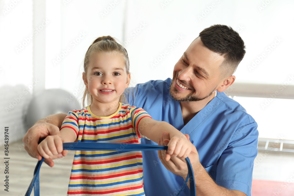 © New Africa - Orthopedist working with little girl in hospital gym