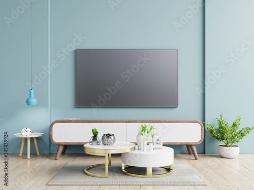 Smart TV on the dark blue wall in living room minimal design.