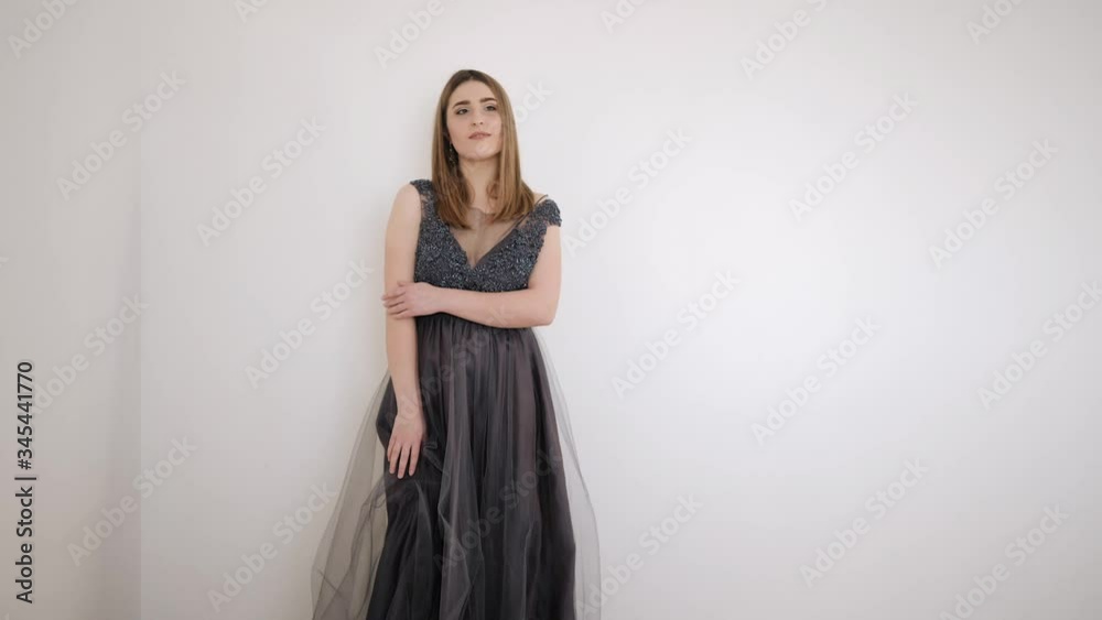 beautiful woman in purple evening dress posing sitting on a white background beautiful woman in purple evening dress posing sitting on a white background