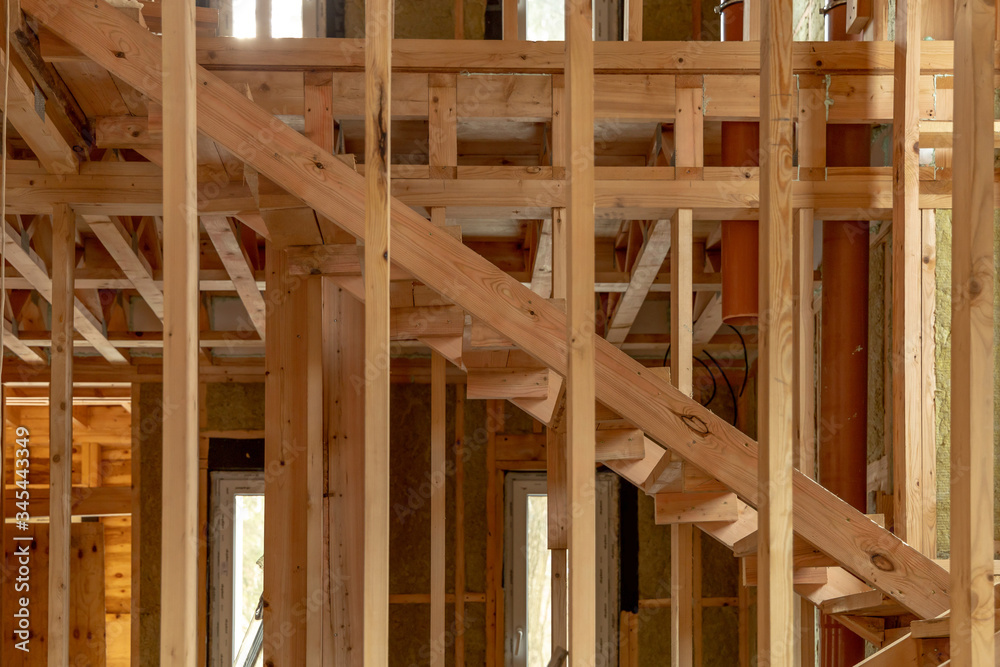 Fototapeta premium Construction of a new frame house. Wooden structures indoors