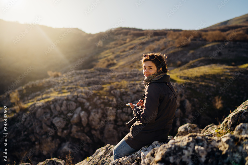 Young woman spending free time in national park/mountains.Hiking outdoor experience.Nature adventure.Woman appreciating nature and natural beauty.Activist.Environmental Protection and Sustainability