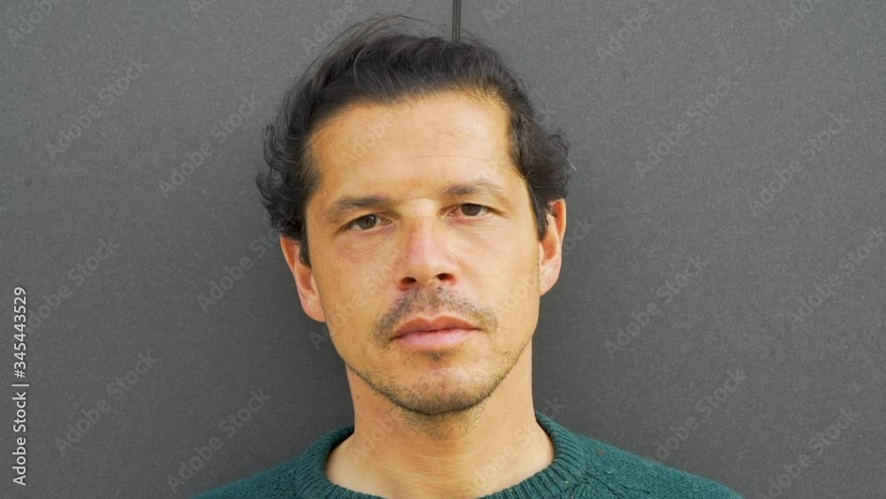 Man looking straight into the camera with a serious face expression