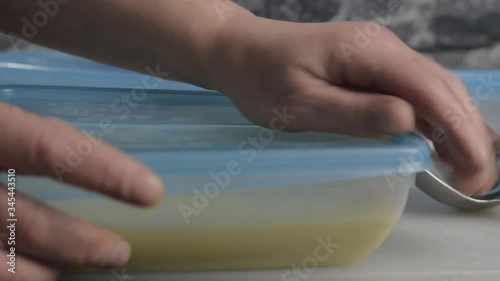 Wallpaper Mural Putting lid onto plastic food container close up shot Torontodigital.ca