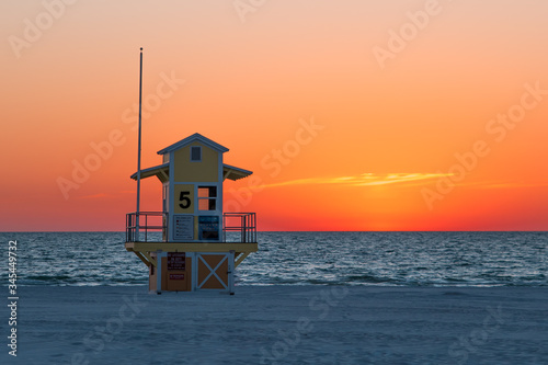 Lifeguard tower on the beach. Ocean sunset. White quartz sand. Summer vacation.