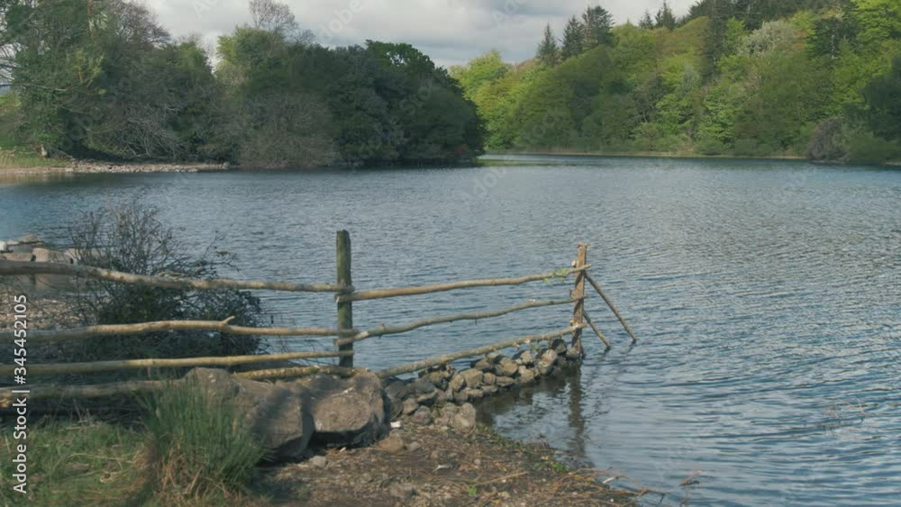 Hand built fencing made with trees river shoreline Hand built fencing made with trees river shoreline