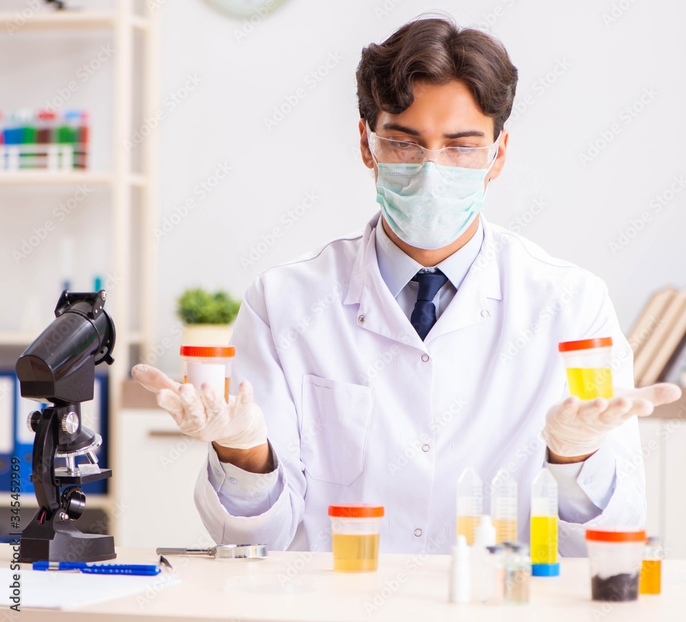 Young handsome chemist working in the lab Young handsome chemist working in the lab