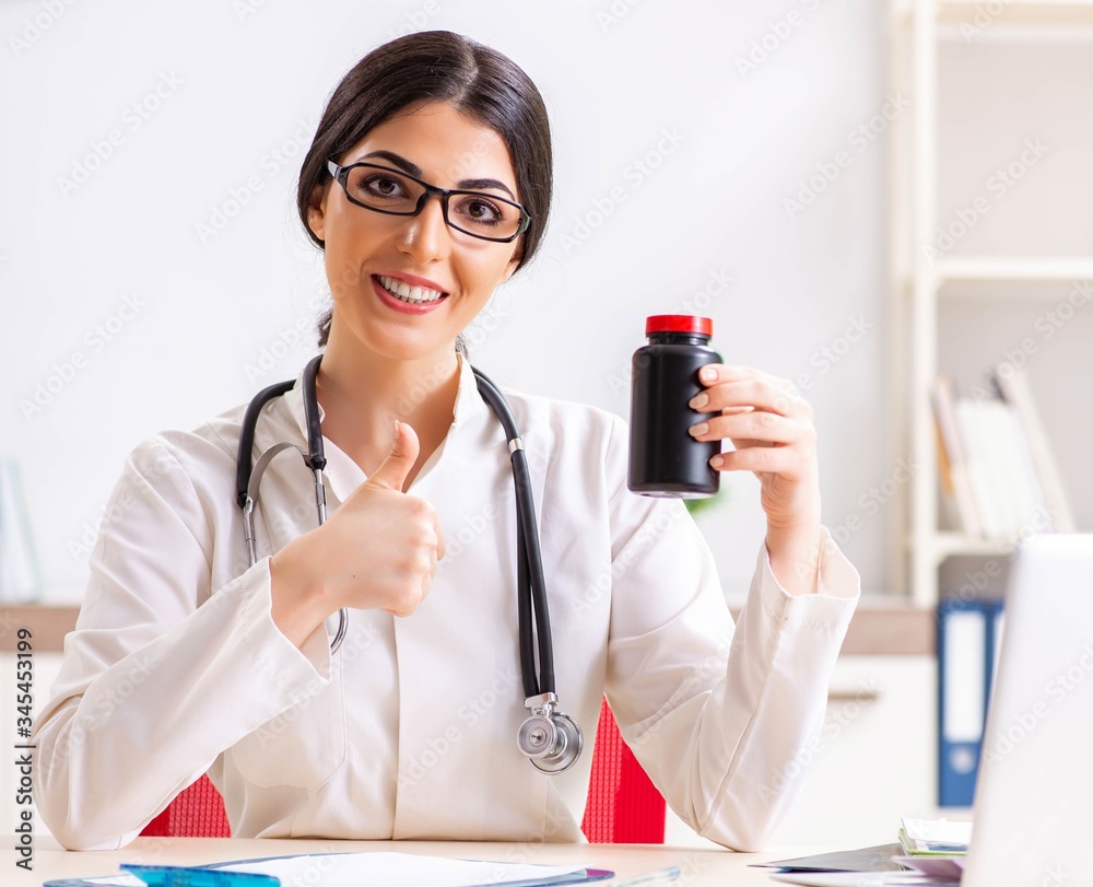 Woman doctor with bottle of medicines Woman doctor with bottle of medicines