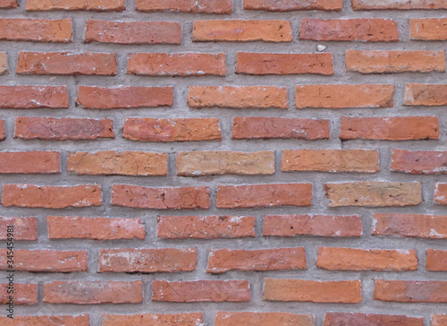 Orange field brick texture background. Natural brick wall  exposed exposed masonry wall illuminated by sunlight.