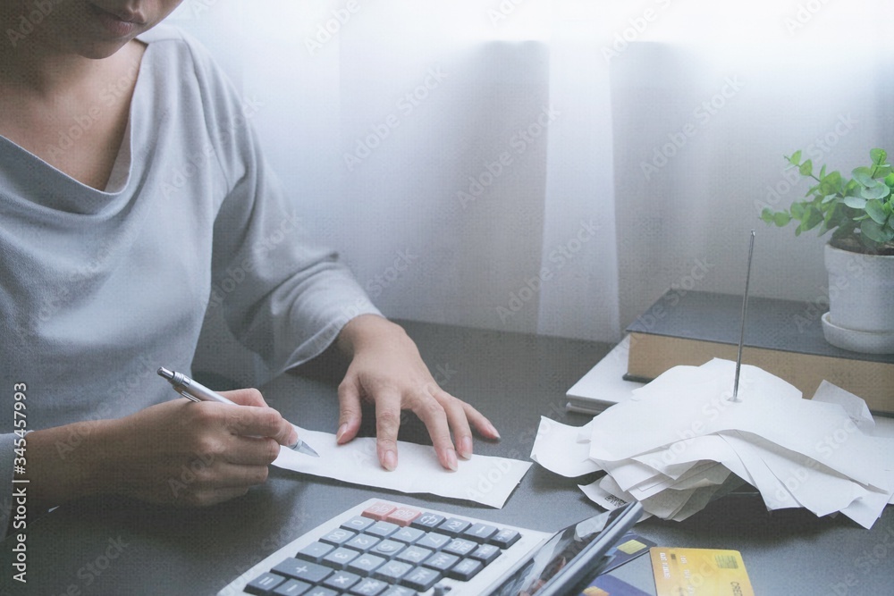 Φωτογραφία Hand of Asian woman writing a bill, receipt, report, financial statement of cred